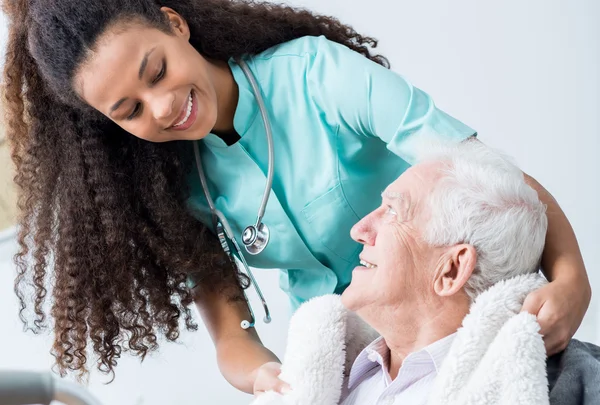 depositphotos_118528316-stock-photo-caregiver-and-elderly-man-smiling